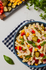 Italian fusilli pasta in a salad with ham and vegetables.