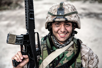 Smiling army soldier, United States Marine Corps infantry shooter in camo battle uniform, protected...
