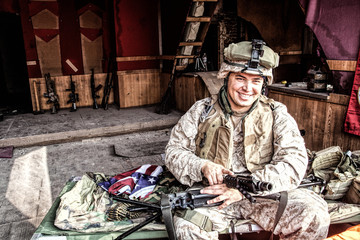 Marine Corps machine gunner smiling, disassembling, making maintenance of service weapon, checking...