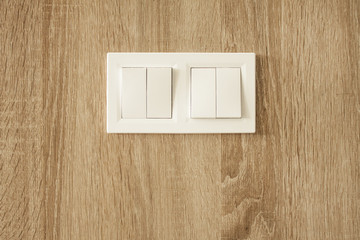White switch on wooden panel