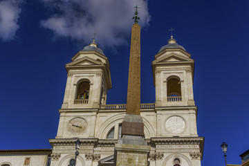 Fototapeta na wymiar Rome Italy Santissima Trinita dei Monti church at Spanish Steps. Day view of Roman Catholic titular church facade with bell towers and obelisk above Piazza di Spagna.