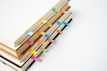 close up of book marked with placeholders on white background.