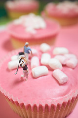 Miniature golfer on pink cake