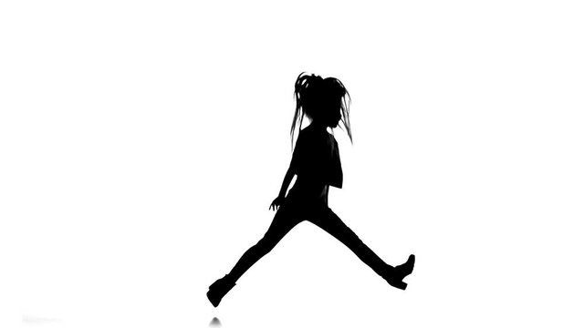 Kid dances to sit on the twine . White background. Silhouette. Slow motion