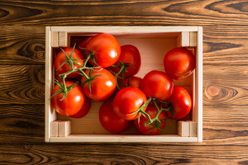 Overhead view of tomatoes in wooden crate