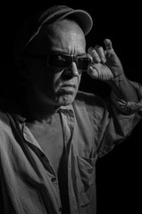 An elderly man in a cap.