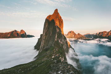 Segla Mountain sunset peak Landscape over clouds and fjord view in Norway Travel location scenery Senja islands midnight sun