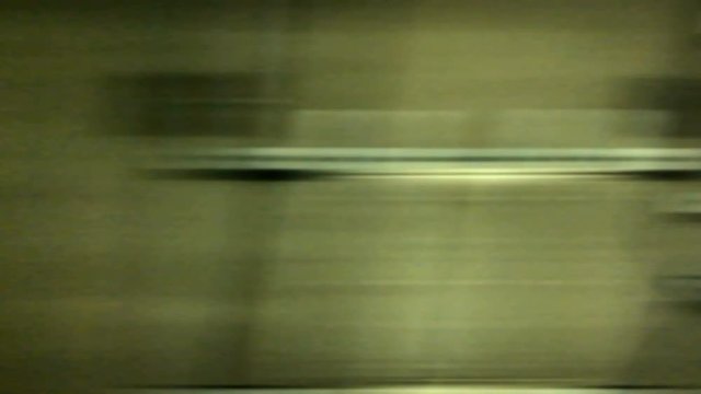 Uhd Footage :  Out side view of Underground train run through the tunnel . The tunnel wall and illuminate light