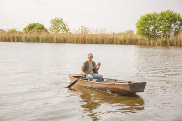 man fishing on a lake- Fisherman in fishing boat .