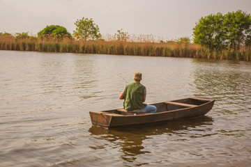 Fototapeta na wymiar Fisherman catching fish -man fishing on a lake.