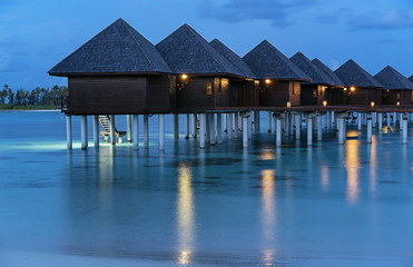 Luxury water villa sunset in Maldives