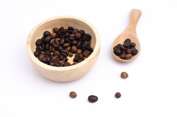 Ground coffee and coffee beans in the wood bowls on white background