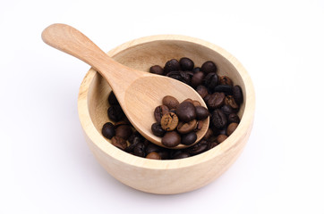 Ground coffee and coffee beans in the wood bowls on white background