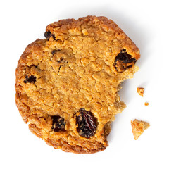 Partially eaten oat and raisin round biscuit isolated on white from above.