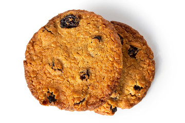 Two oat and raisin round biscuits isolated on white from above.