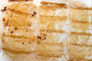 Background of used wax paper baking sheet with baking marks.