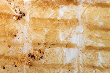 Background of used wax paper baking sheet with baking marks.