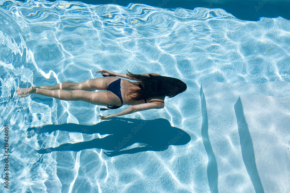 Wall mural woman swims underwater