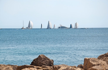 Beautiful coastal landscape with sailing regatta and rocks in Mallorca, Spain
