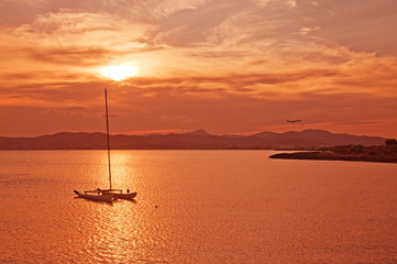 Beautiful sunset view over Palma bay with moored sailboat on a sunny summer evening in July, Mallorca, Spain.