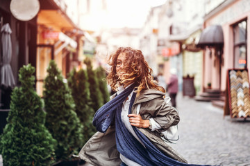 Pretty curly girl walking on the street
