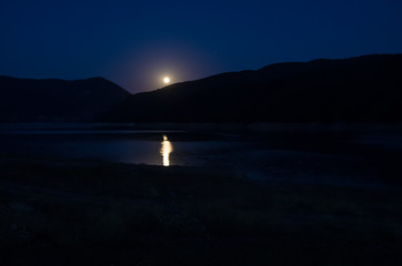 lake  in mountains at night in full moon light