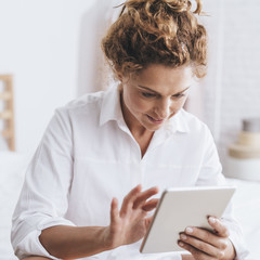 Woman Using Tablet at Home