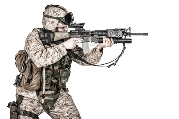 Studio shoot of yelling army soldier with machine gun, Marine Corps machine gunner in camo uniform...