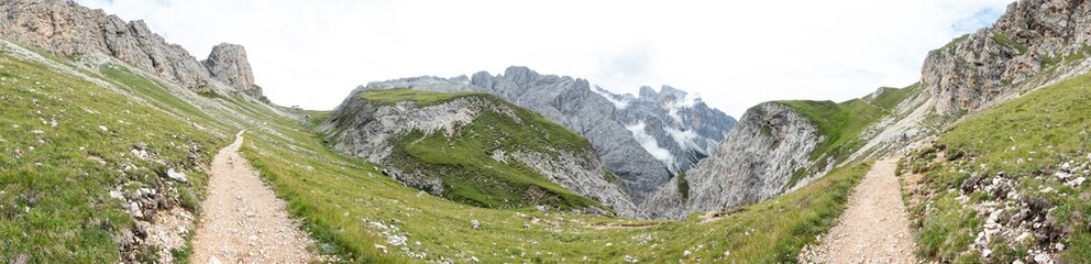 Fototapeta na wymiar Panorama view of mountains and a hiking trail near Sciliar