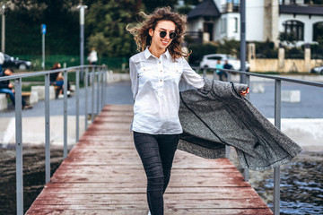 Cute girl with curly hair near lake