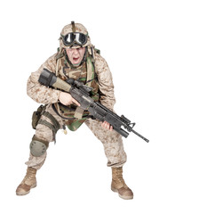 Studio shoot of modern infantry soldier, U.S. marine rifleman in combat uniform, helmet and body armor, screaming and crouching down with assault service rifle in hands isolated on white background