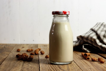 Traditional Spanish horchata made of tiger nuts, non-dairy milk, in a glass bottle, copy space