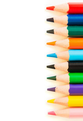Color pencils in row isolated on white background.