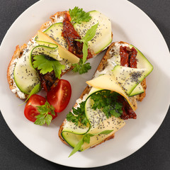 bread slice with zucchini, tomato and cheese