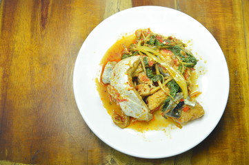 spicy fried striped catfish with herb and curry on plate