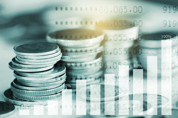 Stack of coins with growing graph for business finance concept
