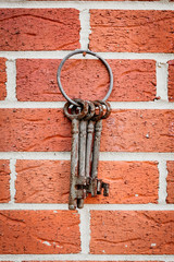 A bunch of old rustic keys. Outdoors.