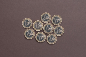 nine coins in one Euro on a dark background top view