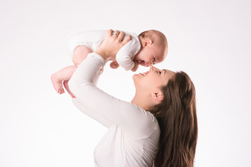 happy mother with newborn daughter on hands