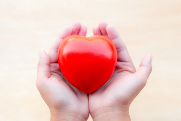 Fototapeta premium Red heart in hands