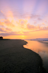 Fototapeta na wymiar Tropical Sunrise over Pacific Ocean Sandy Beach in Mexico.