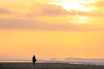 Mexican Fisherman Walking on Pacific Ocean Beach at Sunrise.