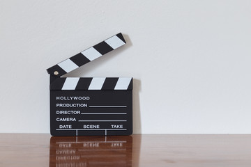 Clapper board on wooden table