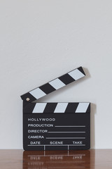 Clapper board on wooden table