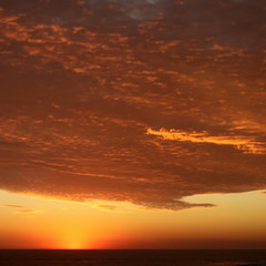 Dramatic Volcanic Crimson Sunset over Pacific Ocean