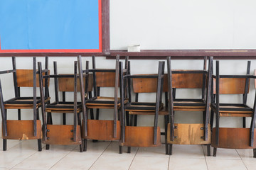 Chairs stacking in row inside the classroom 