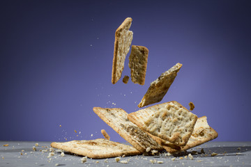 Biscuits floating on white wooden table and purple background