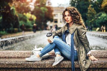 Happy girl with curly hair enjoy drink outdoor