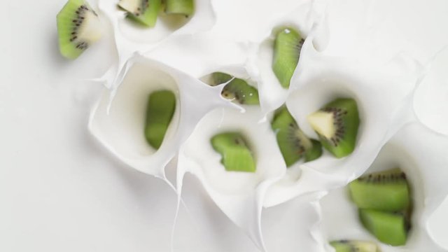 Tossing cut kiwi in yoghurt. Shot with high speed camera, phantom flex 4K. Slow Motion.