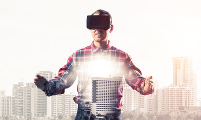 Guy wearing checked shirt and virtual mask stretching hands and 
